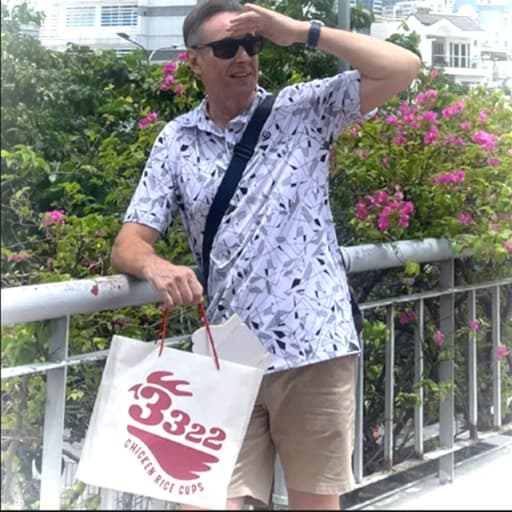 A customer carrying a 3322 Chicken Rice Cups take-away bag